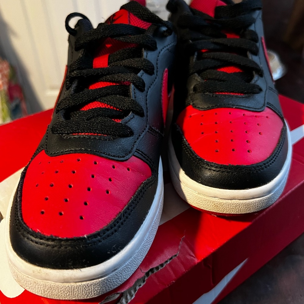 Black and red jordan lows 1s